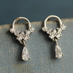 A pair of elegant silver earrings with dangling crystal pendants.