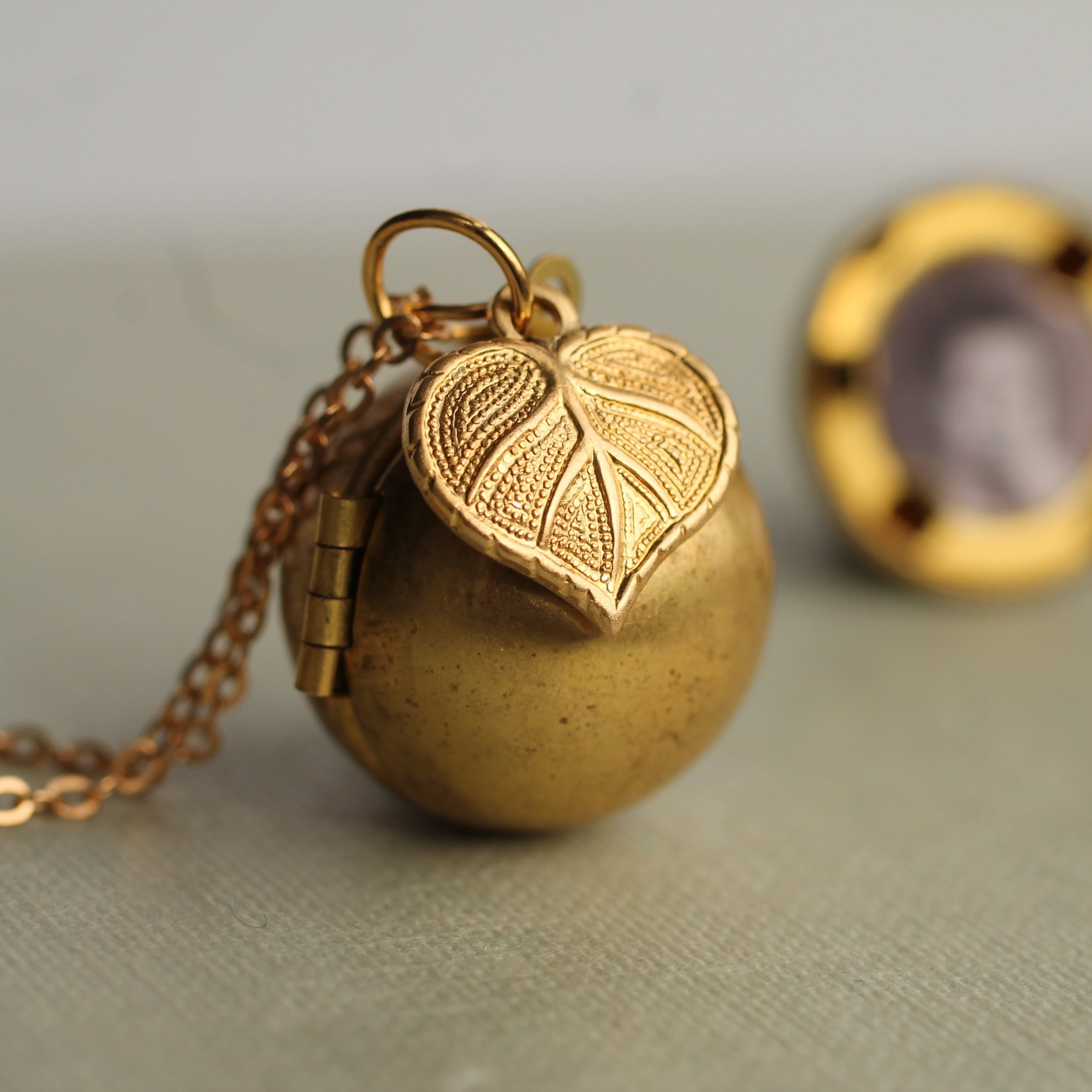Gold Brass Sphere Locket with Tiny Leaf