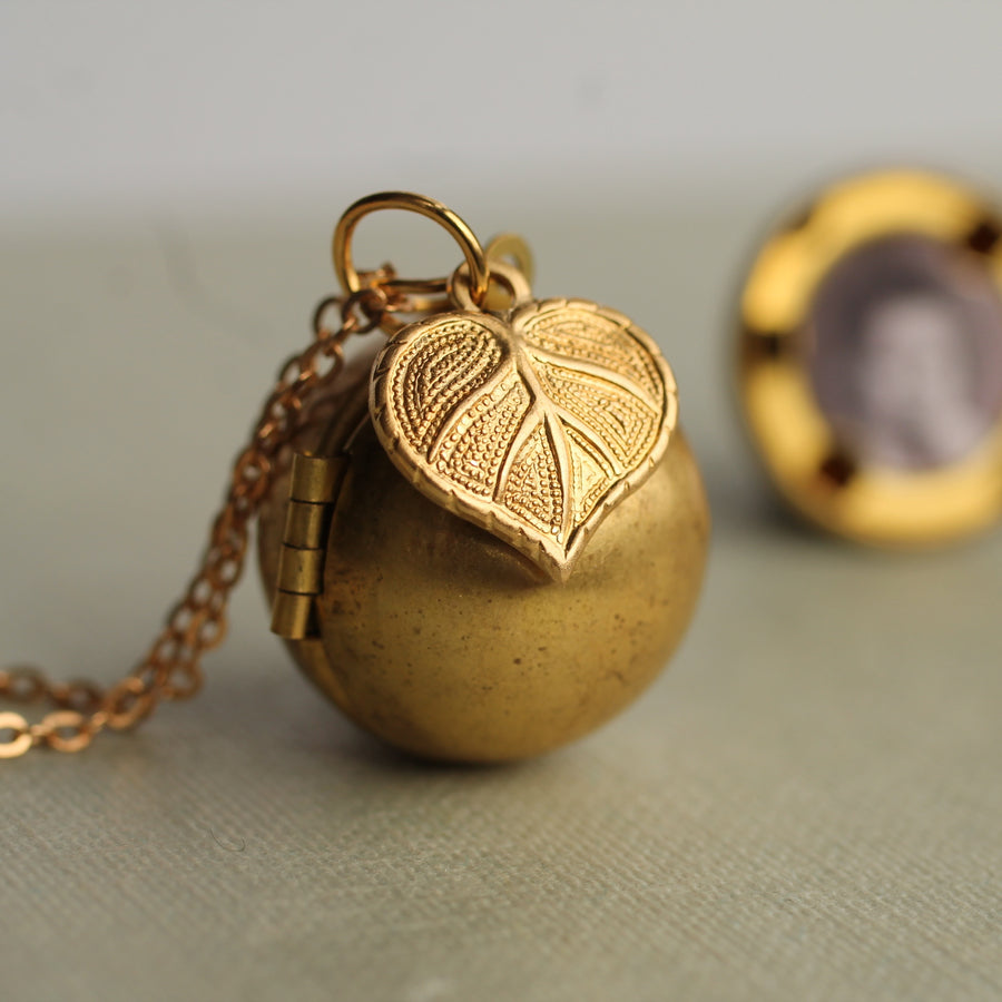 Gold Brass Sphere Locket with Tiny Leaf